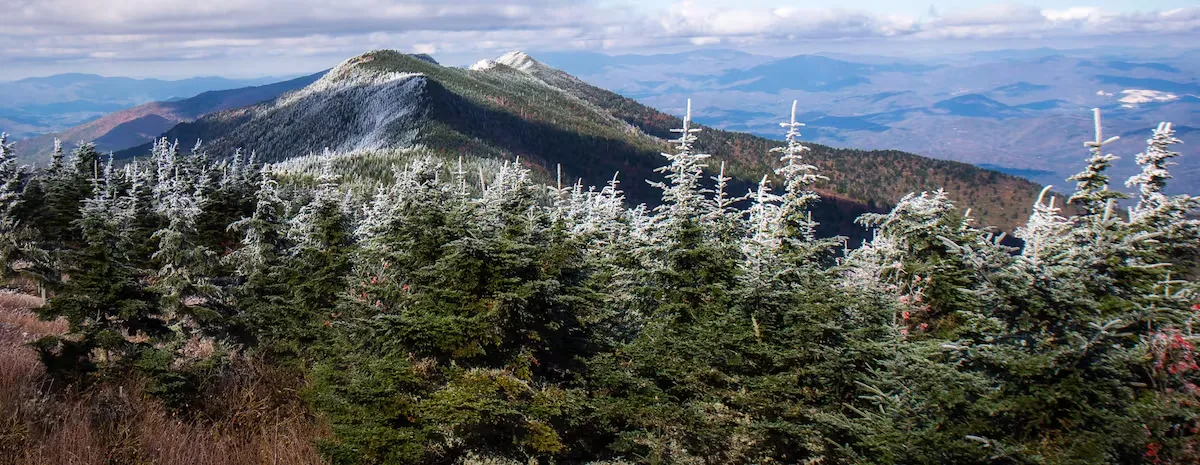 A cozy Appalachian mountain town with fall foliage or a peaceful riverside view.