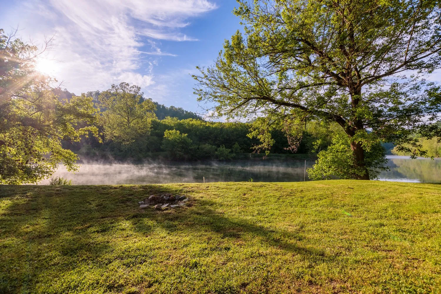 Scenic view of the Clinch River near Kyles Ford, surrounded by Appalachian forest and hills.