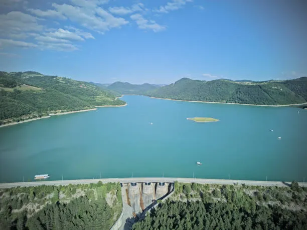 A scenic view of Watauga Lake in Tennessee, showcasing calm waters surrounded by lush green hills.