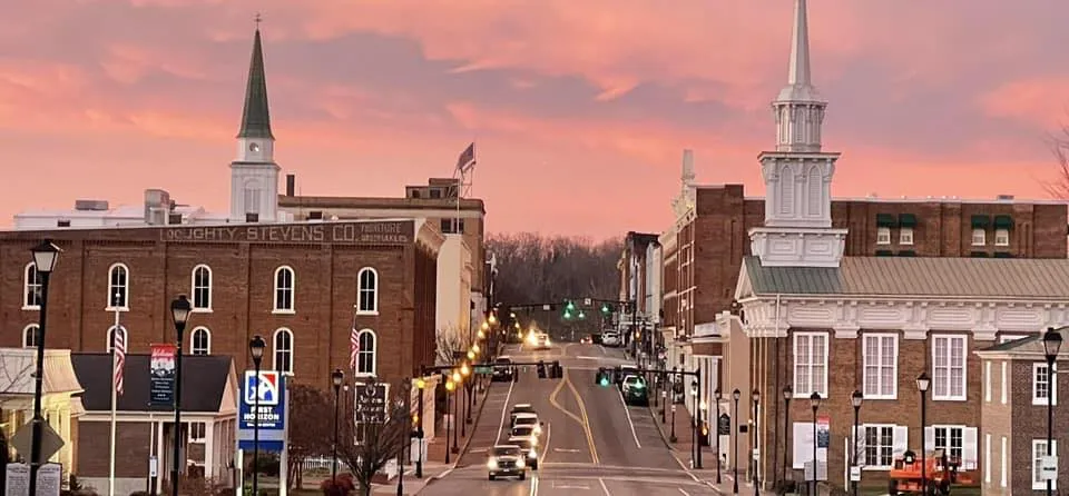 Downtown Greeneville, Tennessee, with historic buildings and a scenic backdrop of the Appalachian Mountains.